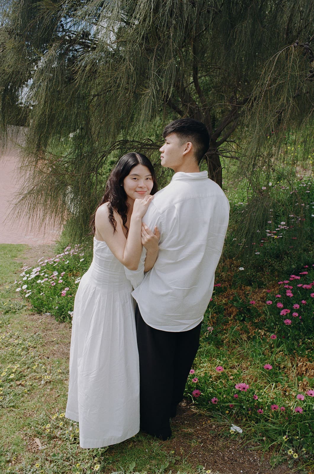 Kobe and Chesqa embracing under the trees