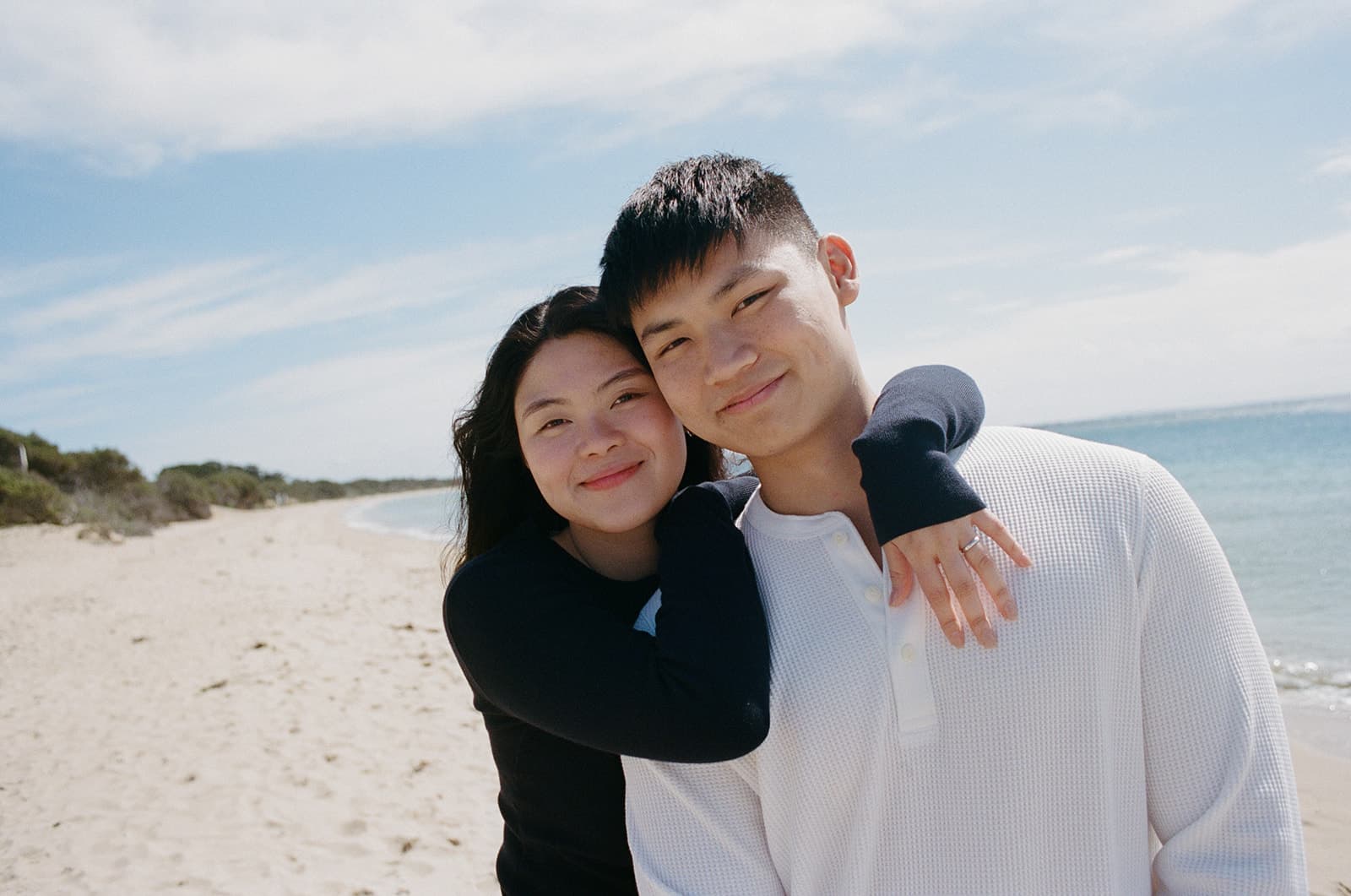 Chesqa hugging Kobe from behind on the beach