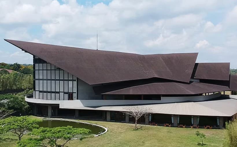 Magnificat Hall, a large building with a sweeping dark roof